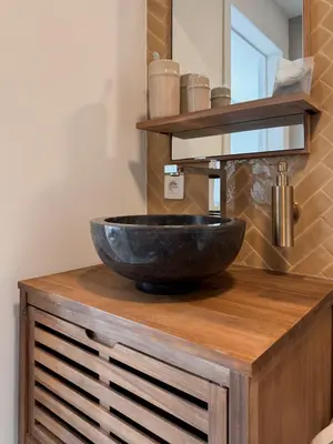 a bathroom with a bowl sink on a wooden counter at Business Accommodation 'Scandinavian Living' Nomad in Geel