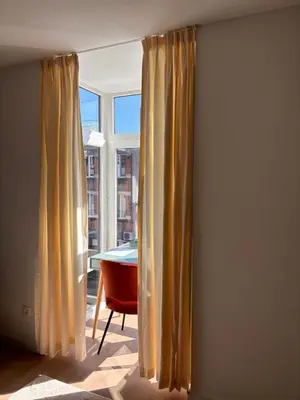 a room with a table and a window with curtains at Business Accommodation 'Scandinavian Living' Nomad in Geel