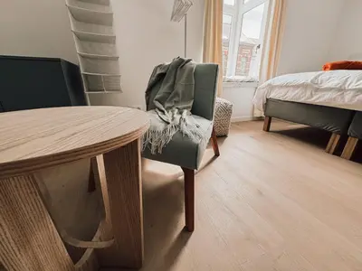 a room with a table and a chair and a bed at Business Accommodation 'Flow Living' Nomad in Geel