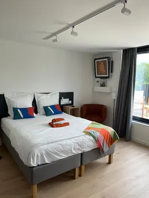 a bedroom with a bed and a window at Business Accommodation 'Urban Living' Intimate in Geel