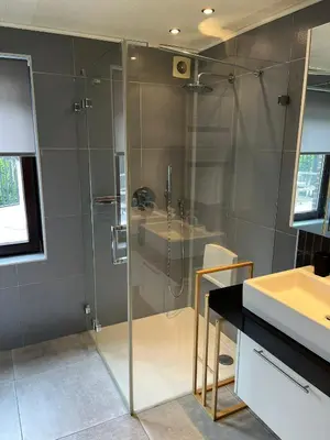 a bathroom with a glass shower and a sink at Business Accommodation 'Urban Living' Intimate in Geel