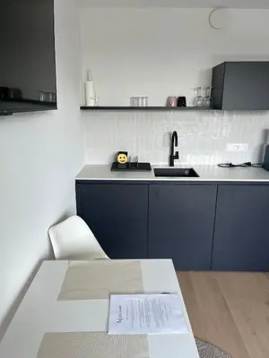 a kitchen with a table with a paper on it at Business Accommodation 'Urban Living' Intimate in Geel