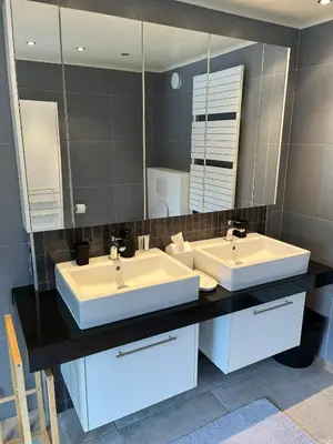 a bathroom with two sinks and a large mirror at Business Accommodation 'Urban Living' Intimate in Geel