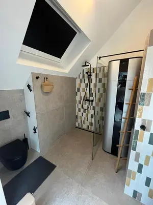 a bathroom with a shower and a tv on the ceiling at Business Accommodation 'Loft' Intimate in Geel