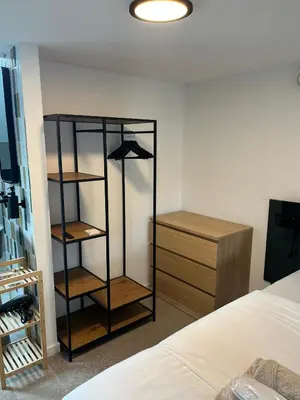 a bedroom with a book shelf and a bed at Business Accommodation 'Loft' Intimate in Geel