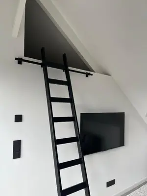 a ladder leading up to a tv in a white wall at Business Accommodation 'Loft' Intimate in Geel