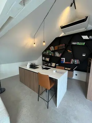 an office with a desk and a chair in a room at Business Accommodation 'Loft' Intimate in Geel