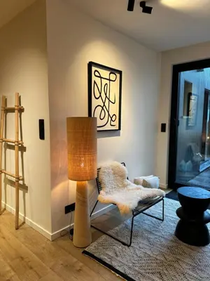 a living room with a lamp and a couch at Luxury Apartment with Cosy Garden! in Ghent