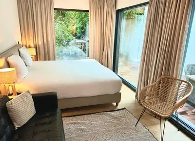 a bedroom with a bed and a large window at Luxury Apartment with Cosy Garden! in Ghent