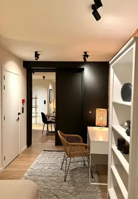 a living room with a desk and a table at Luxury Apartment with Cosy Garden! in Ghent