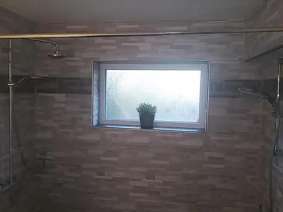 a bathroom with a window and a potted plant on the window sill at VILLA EXPO in Brussels