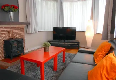 a living room with a couch and a red coffee table at VILLA EXPO in Brussels