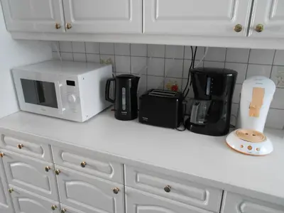a kitchen counter with a microwave and appliances on it at VILLA EXPO in Brussels