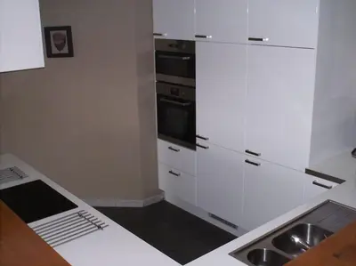 a kitchen with white cabinets and a sink at Huis met 4 slaapkamers tussen Antwerpen en Brussel in Rumst
