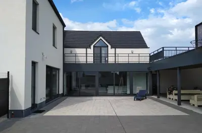 a house with a balcony and a patio at Molenbaan28 in Merchtem