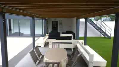 a screened in porch with chairs and a couch at Molenbaan28 in Merchtem