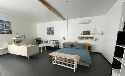 a bedroom with a bed and a couch and a chair at Molenbaan28 in Merchtem