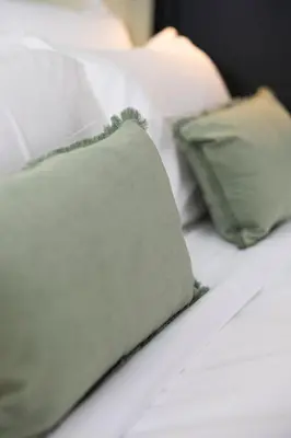 a close up of a bed with pillows on it at Atelier K - Art Guesthouse in Brussels in Brussels