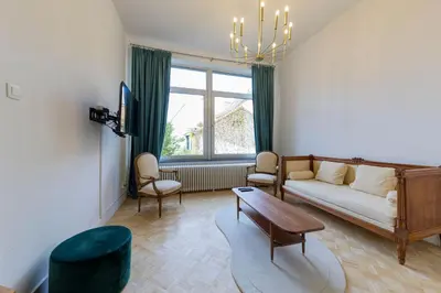 a living room with a couch and a table at Atelier K - Art Guesthouse in Brussels in Brussels