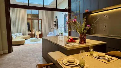 a living room with a table with a vase of flowers at De Gulden Poorte, a LXRYHOME Hotel Collection in Antwerp