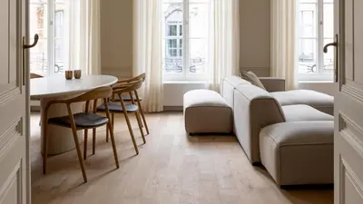 a living room with a table and a couch at De Gulden Poorte, a LXRYHOME Hotel Collection in Antwerp