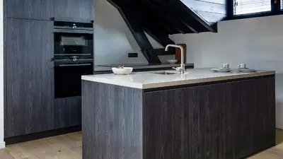 a kitchen with a sink and a stove at De Gulden Poorte, a LXRYHOME Hotel Collection in Antwerp