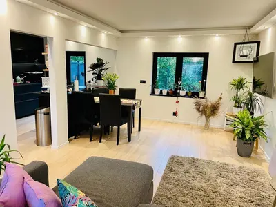 a living room with a table and a dining room at Town house with garden - 1 room with shared bathroom in Brussels