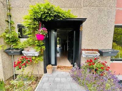 an open door with plants and flowers on a building at Town house with garden - 1 room with shared bathroom in Brussels