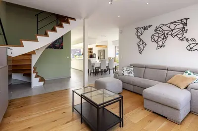 a living room with a couch and a table at Lichtrijke woning vlakbij Leuven in Herent