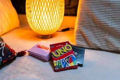 a table with two snacks and a lamp on a bed at Spacious Shared 5BR Apt in the Heart of Gent in Ghent