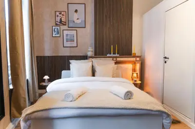 a bedroom with a bed with two towels on it at Spacious Shared 5BR Apt in the Heart of Gent in Ghent