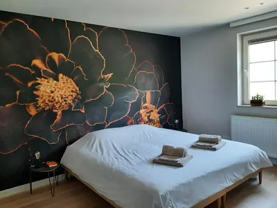 a bedroom with a large flower mural on the wall at B&B De Levensboom in Tessenderlo