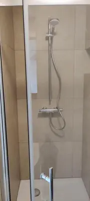 a shower in a bathroom with a glass door at Docs House in Wetteren