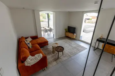 a living room with a couch and a table at Zeer unieke vakantiewoning in Herentals