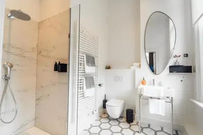 a bathroom with a shower and a sink and a mirror at Luxeverblijf B&B het Wevershuis in Herentals