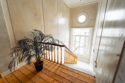 a staircase with a potted plant in a room at Luxeverblijf B&B het Wevershuis in Herentals