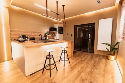 an open kitchen with a counter and two stools at Golden Dove Luxury Apartment in Brussels