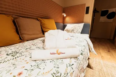 a bed with two towels sitting on top of it at Golden Dove Luxury Apartment in Brussels