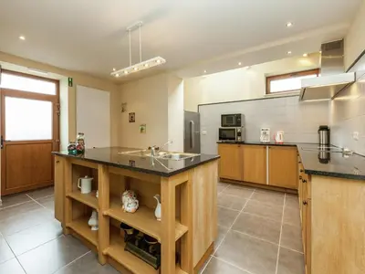 a large kitchen with a sink and a counter at Glabbeek Family Retreat Home in Bunsbeek