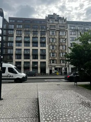 a van parked in front of a large building at Jardin Botanique in Brussels