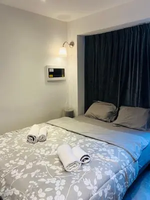 a bedroom with a bed with towels on it at Cosy in Mechelen