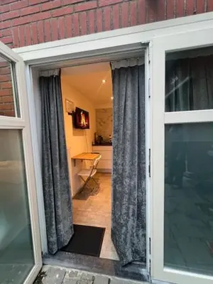 an open door to a room with a kitchen at Cosy in Mechelen