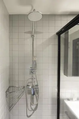 a shower in a bathroom next to a sink at Getaway Leuven in Leuven