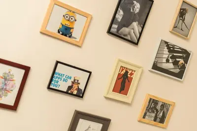 a wall of framed pictures on a white wall at Getaway Leuven in Leuven