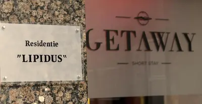 a sign on a building with a sign for a pharmacy at Getaway Leuven in Leuven