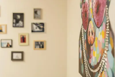 a wall with framed pictures on a wall at Getaway Leuven in Leuven