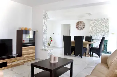 a living room with a couch and a table at Chez Nadège in Affligem
