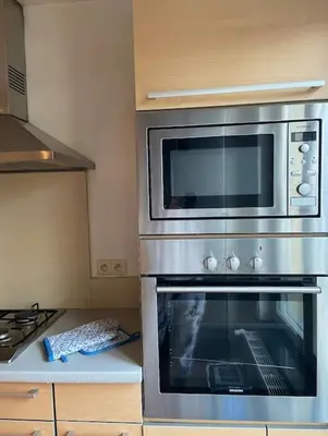 a kitchen with a microwave above a oven at Cute central flat in Brussels in Brussels