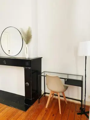 a desk with a mirror and a chair in a room at Cute central flat in Brussels in Brussels