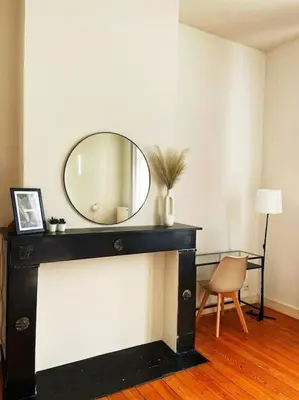 a room with a mirror on a wall with a chair at Cute central flat in Brussels in Brussels
